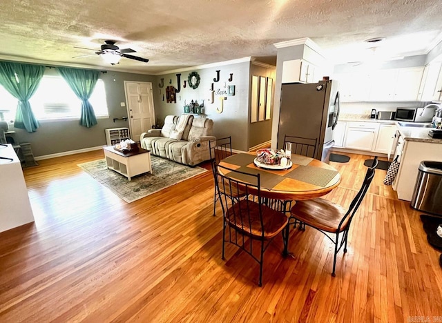6312 Sandy Ln, Little Rock, AR 72204 - dining room featuring a textured ceiling, ceiling fan, ornamental molding, and light wood finished floors