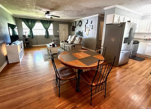 6312 Sandy Ln, Little Rock, AR 72204 - dining area with ceiling fan, a textured ceiling, light wood finished floors, and ornamental molding