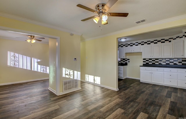 9425 S 365th Hwy, Little Rock, AR 72206 - kitchen with ceiling fan, dark countertops, white cabinets, dark wood-style flooring, and ornamental molding