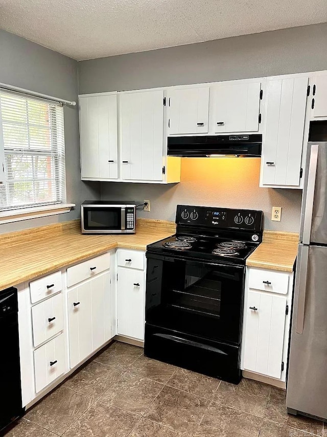 kitchen featuring black appliances, under cabinet range hood, light countertops, white cabinets, and a textured ceiling