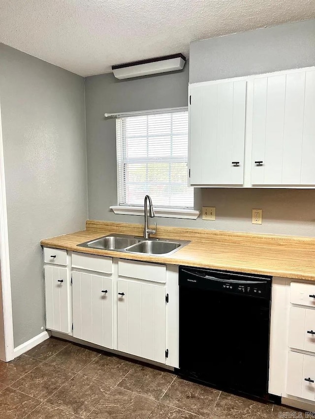 kitchen featuring dishwasher, a textured ceiling, light countertops, and white cabinetry