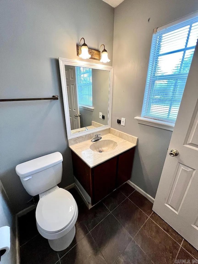 half bathroom featuring tile patterned floors and vanity