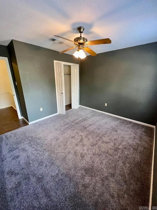 unfurnished bedroom with carpet, a closet, and ceiling fan