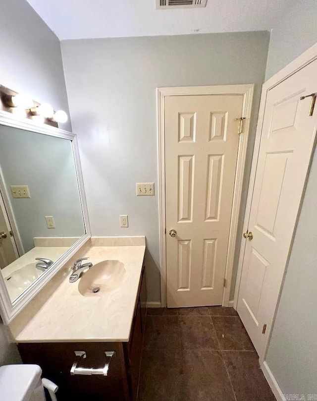 bathroom featuring tile patterned flooring and vanity
