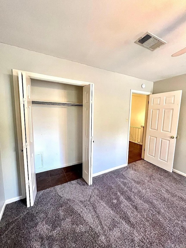 unfurnished bedroom with carpet and a closet