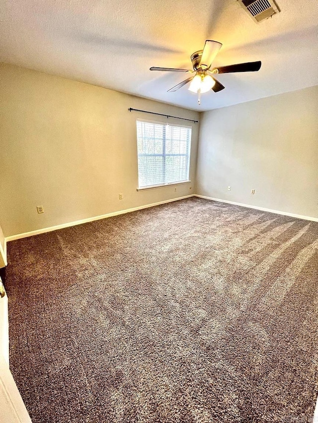 spare room with ceiling fan, carpet, and a textured ceiling