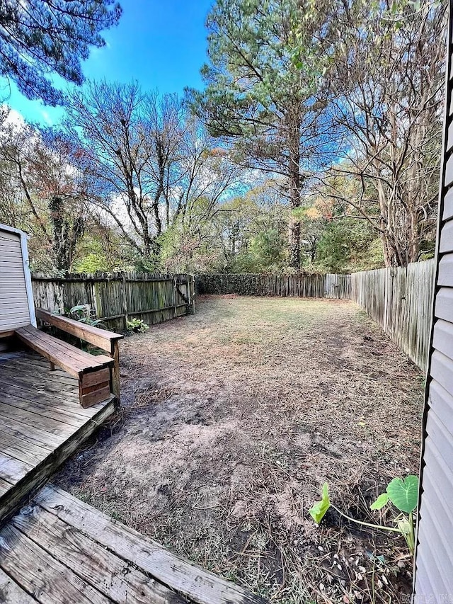 fenced backyard featuring a wooden deck