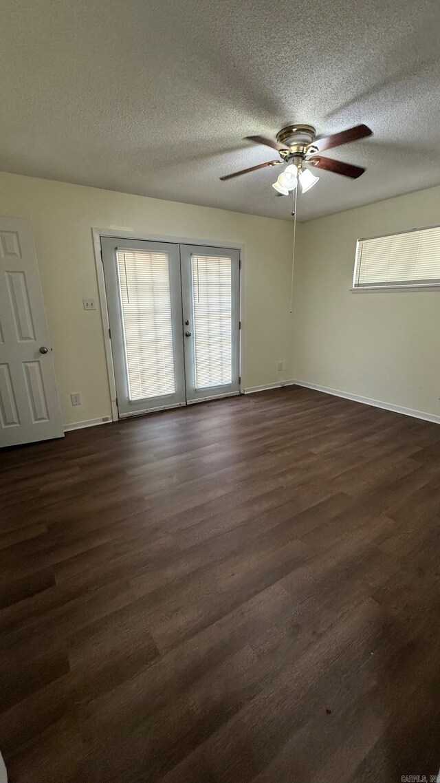3003 Vancouver Dr, Little Rock, AR 72204 - spare room with a textured ceiling, french doors, dark wood-type flooring, and a ceiling fan