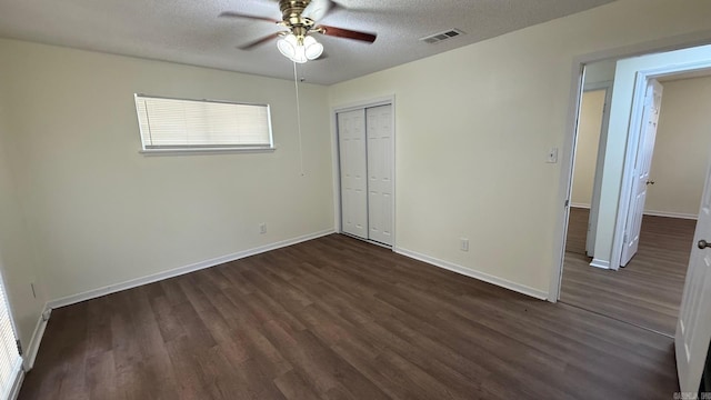 3003 Vancouver Dr, Little Rock, AR 72204 - unfurnished bedroom featuring dark wood finished floors, a closet, a textured ceiling, and ceiling fan
