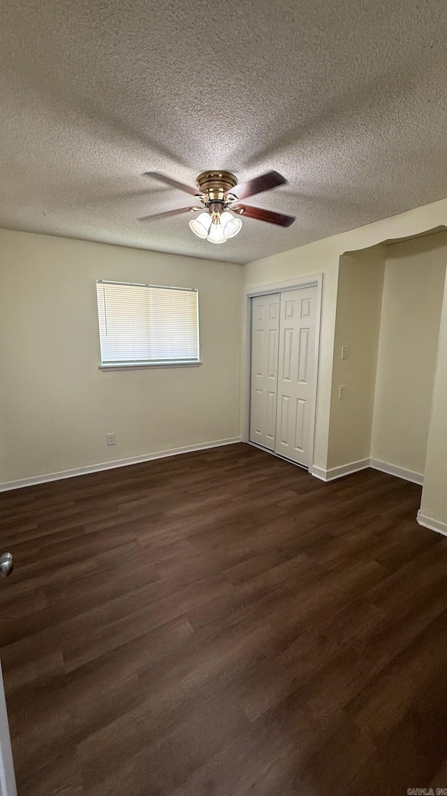 3003 Vancouver Dr, Little Rock, AR 72204 - unfurnished bedroom featuring dark wood-style flooring, a closet, a textured ceiling, and ceiling fan