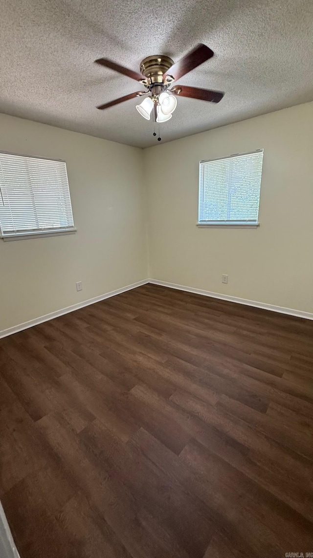 3003 Vancouver Dr, Little Rock, AR 72204 - unfurnished room with dark wood-style flooring, ceiling fan, and a textured ceiling