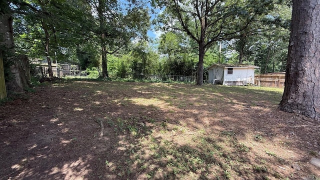 3003 Vancouver Dr, Little Rock, AR 72204 - fenced backyard featuring a storage unit