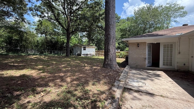 3003 Vancouver Dr, Little Rock, AR 72204 - view of yard featuring a patio and a storage shed