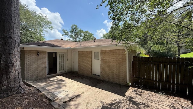 3003 Vancouver Dr, Little Rock, AR 72204 - rear view of property featuring brick siding and a patio area