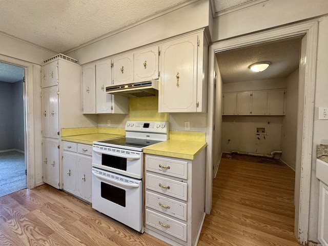 701 Emerald Gardens Dr, North Little Rock, AR 72118 - kitchen with double oven range, under cabinet range hood, a textured ceiling, light wood-style floors, and light countertops