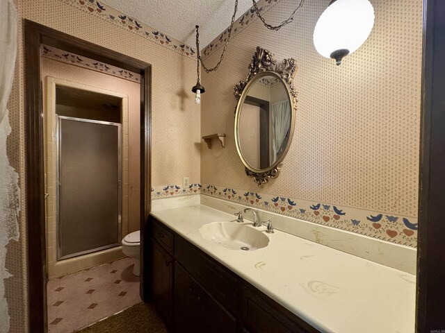 701 Emerald Gardens Dr, North Little Rock, AR 72118 - bathroom featuring vanity, a stall shower, a textured ceiling, and wallpapered walls