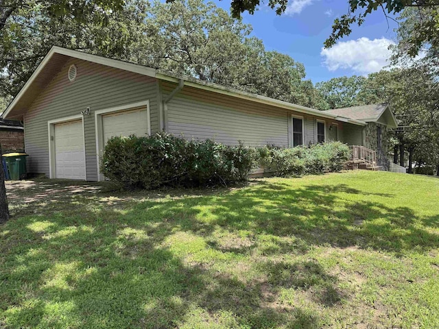 701 Emerald Gardens Dr, North Little Rock, AR 72118 - view of home's exterior featuring a garage, an outbuilding, and a lawn