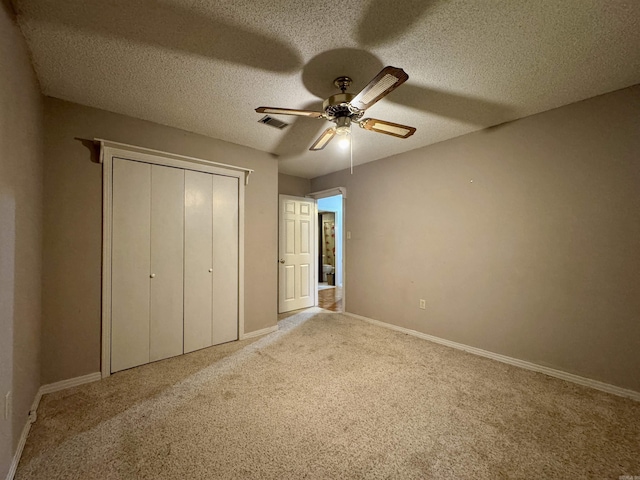 701 Emerald Gardens Dr, North Little Rock, AR 72118 - unfurnished bedroom featuring carpet, a closet, a textured ceiling, and ceiling fan