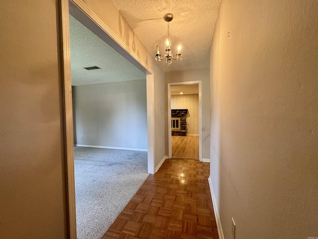 701 Emerald Gardens Dr, North Little Rock, AR 72118 - corridor featuring a chandelier and a textured ceiling