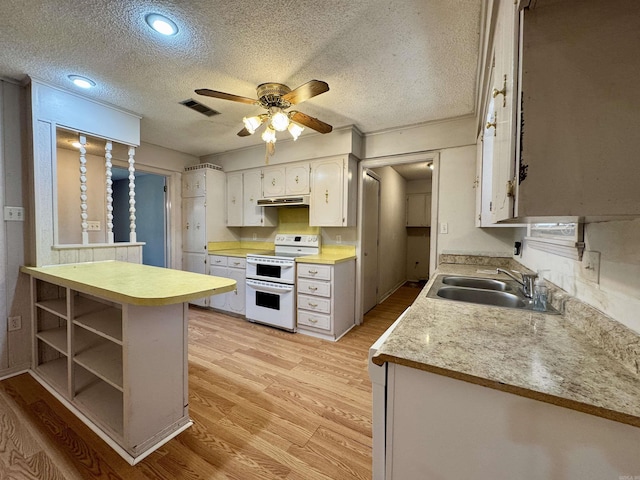 701 Emerald Gardens Dr, North Little Rock, AR 72118 - kitchen featuring double oven range, light countertops, a textured ceiling, light wood finished floors, and a ceiling fan