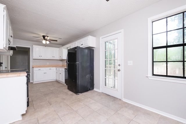 311 Nix Rd, Little Rock, AR 72211 - kitchen with freestanding refrigerator, light countertops, a ceiling fan, stove, and white cabinets