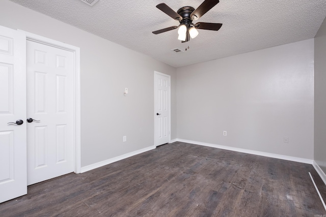 311 Nix Rd, Little Rock, AR 72211 - unfurnished bedroom with dark wood-style flooring, a textured ceiling, and ceiling fan