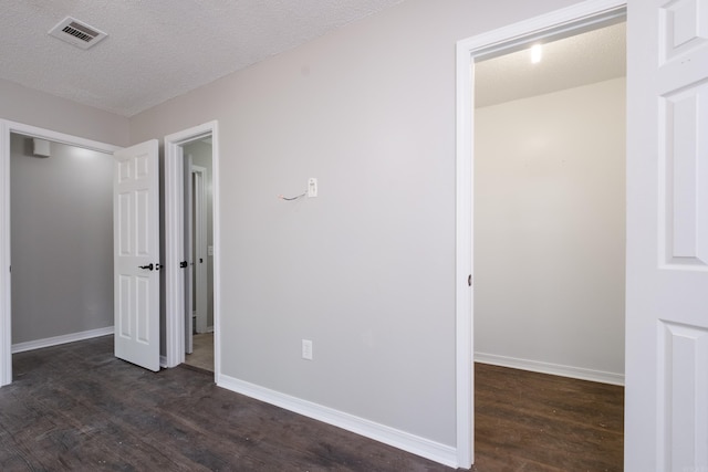 311 Nix Rd, Little Rock, AR 72211 - unfurnished bedroom featuring dark wood-type flooring, a closet, and a textured ceiling