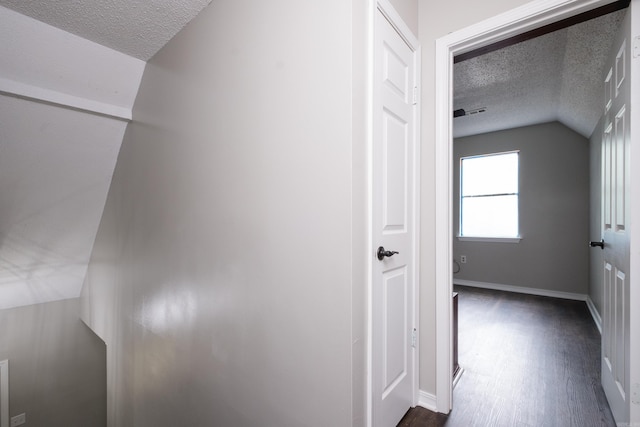 311 Nix Rd, Little Rock, AR 72211 - hallway with a textured ceiling, dark wood-type flooring, and lofted ceiling
