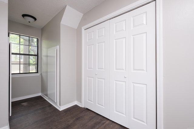 311 Nix Rd, Little Rock, AR 72211 - unfurnished bedroom with dark wood-style floors, a closet, and a textured ceiling