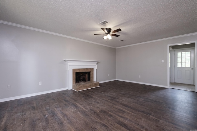 311 Nix Rd, Little Rock, AR 72211 - unfurnished living room with ceiling fan, dark wood-style floors, a tile fireplace, a textured ceiling, and ornamental molding