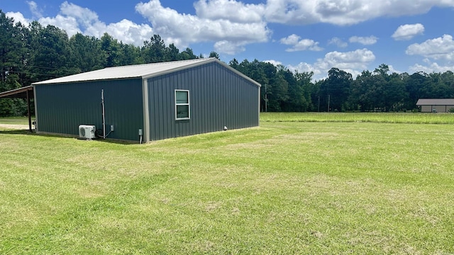 6273 Mc, Fouke, AR 71837 - view of pole building with a lawn, a carport, and a forest view