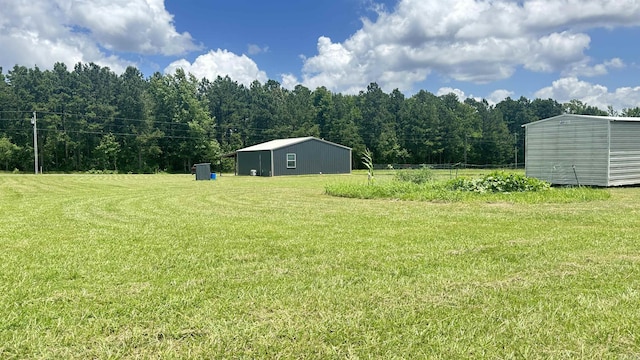 6273 Mc, Fouke, AR 71837 - view of green lawn with an outdoor structure and a view of trees
