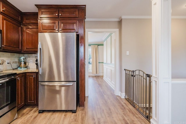 15 Rocky Crest Ct, Little Rock, AR 72211 - kitchen with stainless steel appliances, light wood-type flooring, ornamental molding, tasteful backsplash, and dark brown cabinetry
