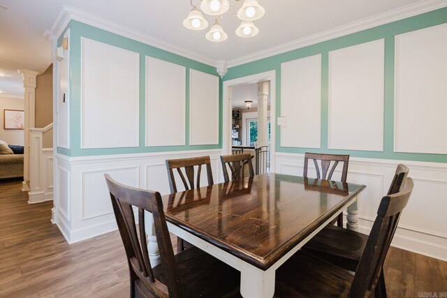 15 Rocky Crest Ct, Little Rock, AR 72211 - dining room featuring a decorative wall, a chandelier, ornamental molding, light wood-style floors, and decorative columns