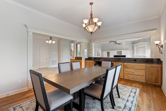 48 Ranch Ridge Rd, Little Rock, AR 72223 - dining space featuring a chandelier, ornamental molding, ceiling fan, and light wood-type flooring