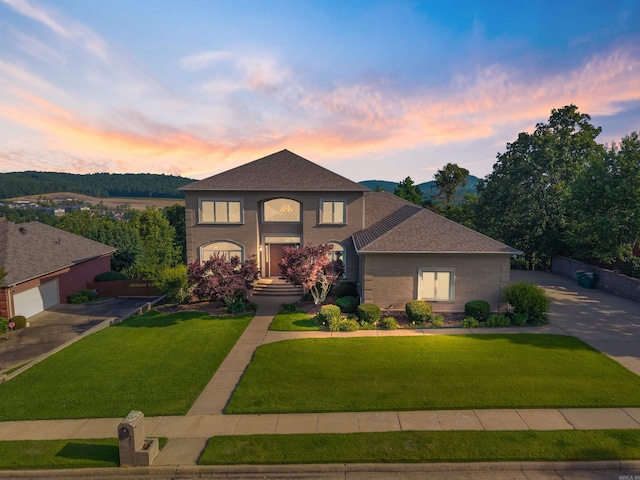 48 Ranch Ridge Rd, Little Rock, AR 72223 - view of front facade featuring a shingled roof, a lawn, a garage, and driveway