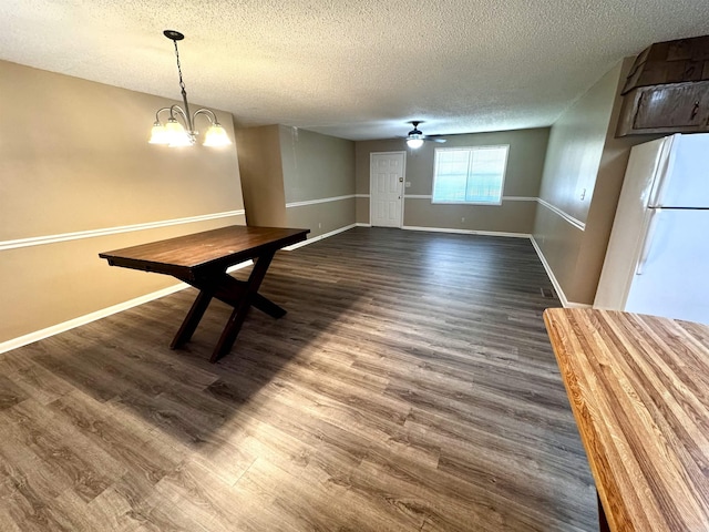 4105 Cedar Valley Dr, Paragould, AR 72450 - unfurnished dining area with a textured ceiling, dark wood-type flooring, a chandelier, and ceiling fan