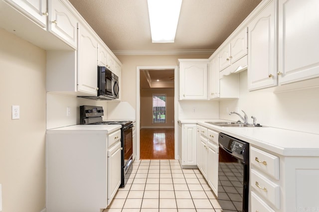 1940 Payne Ln, Conway, AR 72034 - kitchen with black appliances, white cabinetry, crown molding, light countertops, and light tile patterned flooring