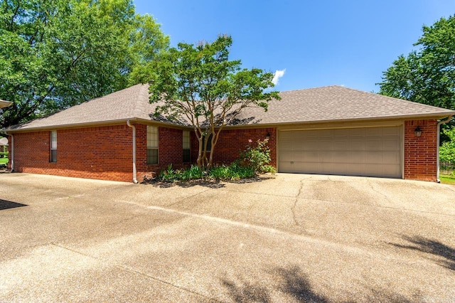 1940 Payne Ln, Conway, AR 72034 - ranch-style house featuring concrete driveway, brick siding, a garage, and a shingled roof