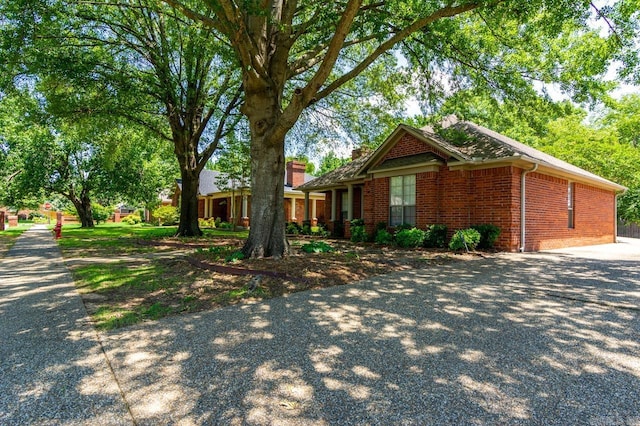 1940 Payne Ln, Conway, AR 72034 - view of front of home featuring brick siding, a chimney, and driveway