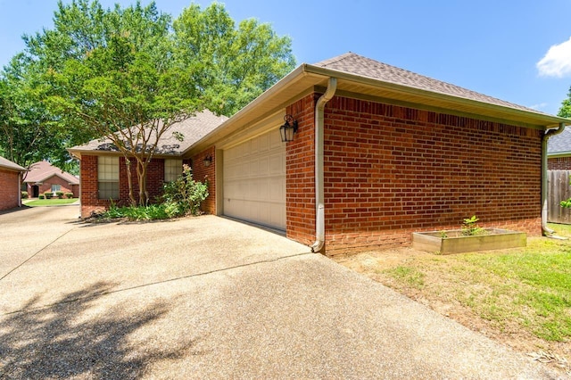 1940 Payne Ln, Conway, AR 72034 - view of side of property featuring brick siding, a garage, driveway, and a shingled roof
