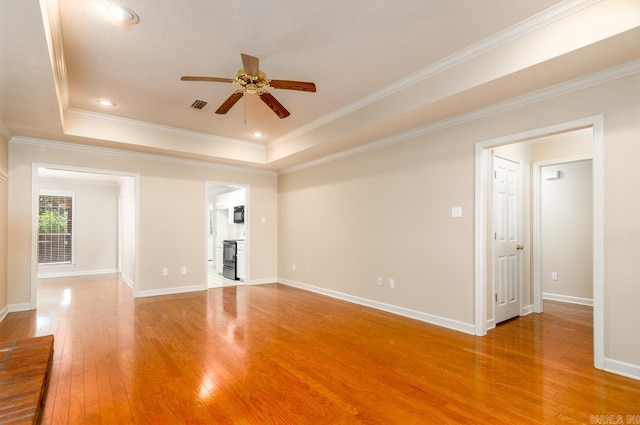 1940 Payne Ln, Conway, AR 72034 - unfurnished room with ceiling fan, light wood-style flooring, ornamental molding, and a raised ceiling
