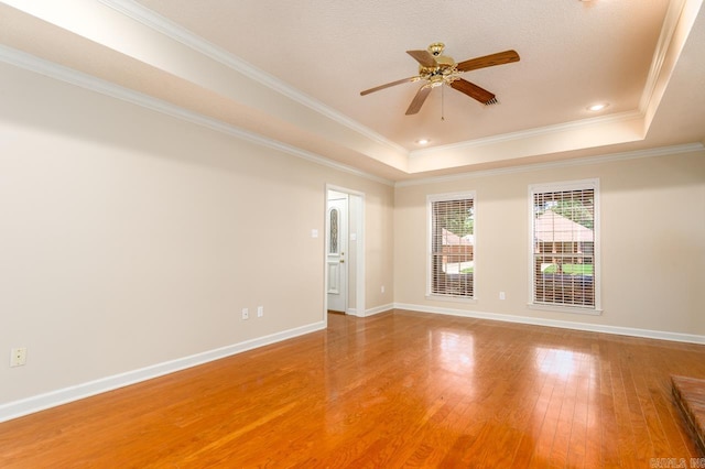 1940 Payne Ln, Conway, AR 72034 - empty room featuring a tray ceiling, a ceiling fan, light wood-type flooring, and crown molding