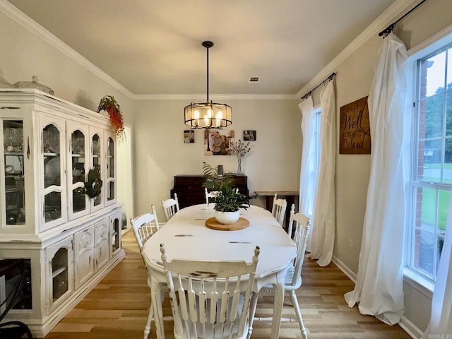 4202 Stephanie, Jonesboro, AR 72401 - dining space featuring light wood-style floors, a chandelier, and crown molding