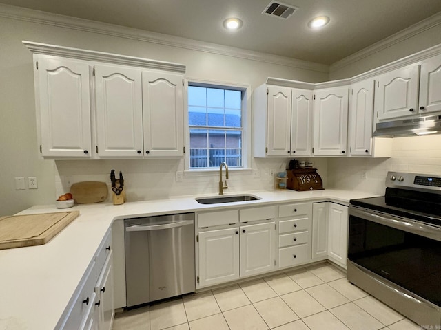 4202 Stephanie, Jonesboro, AR 72401 - kitchen with stainless steel appliances, under cabinet range hood, decorative backsplash, white cabinetry, and crown molding