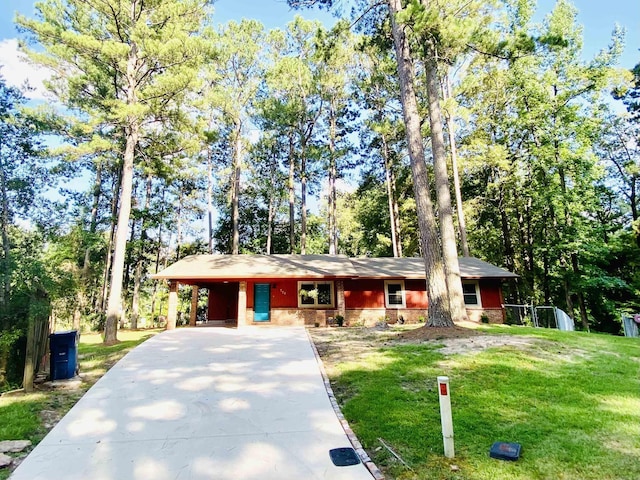 779 Brenda St, Camden, AR 71701 - single story home with concrete driveway, a front lawn, an attached carport, and stone siding