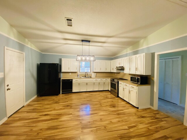 779 Brenda St, Camden, AR 71701 - kitchen featuring black appliances, vaulted ceiling, white cabinets, light wood-style flooring, and pendant lighting