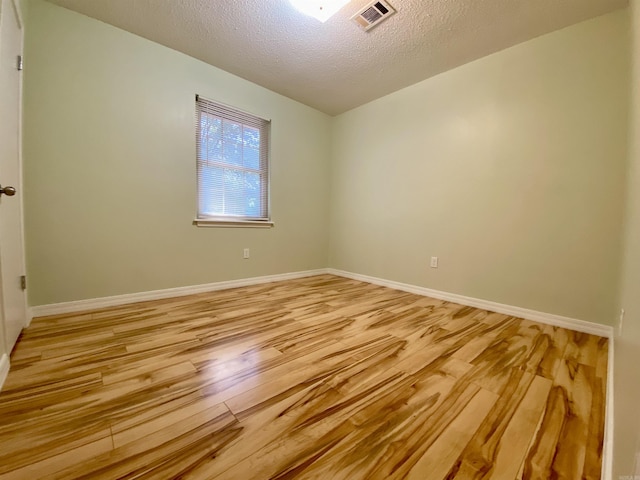 779 Brenda St, Camden, AR 71701 - empty room with light wood-type flooring and a textured ceiling