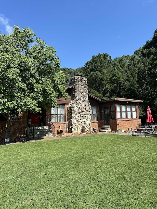 14400 Pikewood Dr, Alexander, AR 72002 - rear view of property with brick siding, a lawn, a chimney, and entry steps