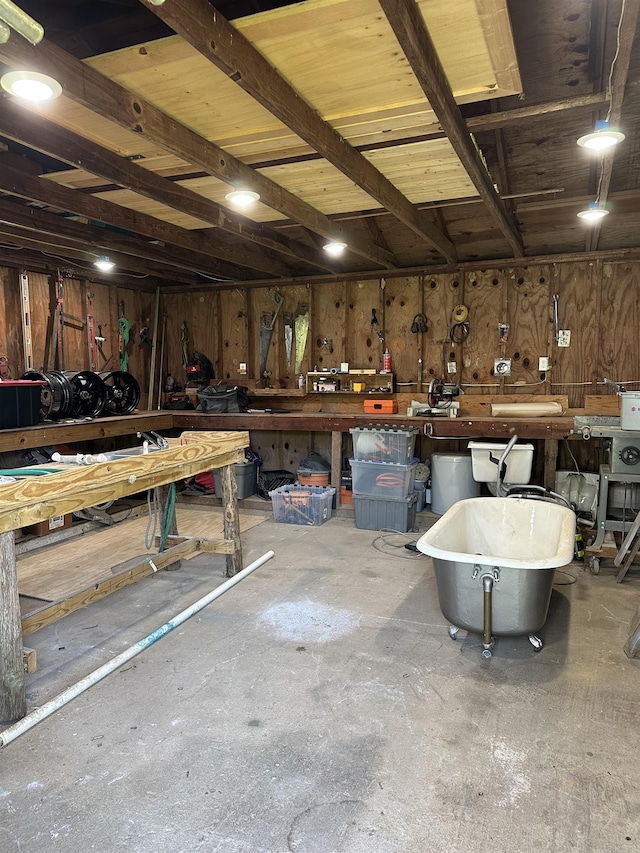 14400 Pikewood Dr, Alexander, AR 72002 - garage with a workshop area and wood walls